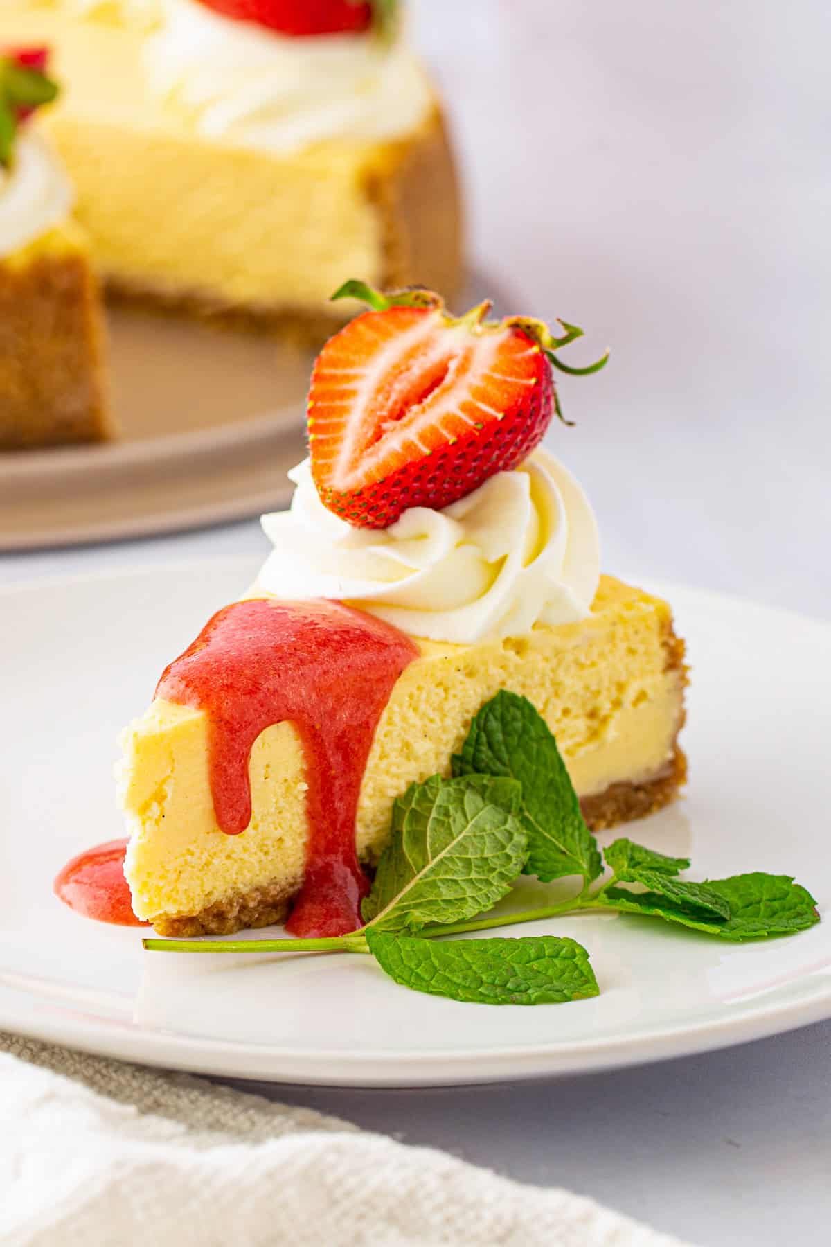 Vanilla Bean Cheesecake with Fresh Strawberry Sauce